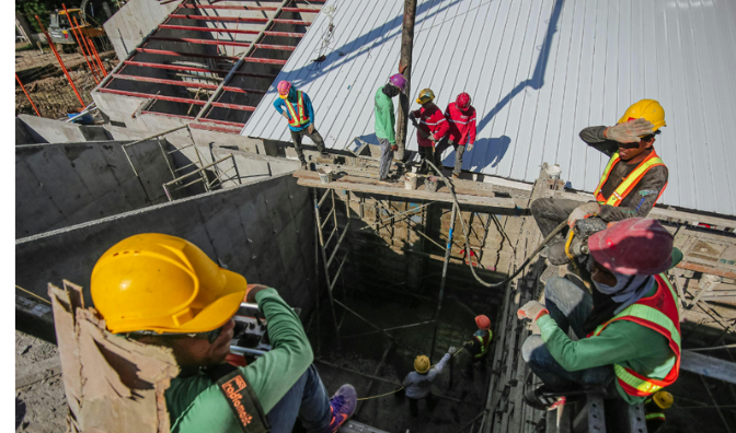 workers on scaffolds wearing safety helmets